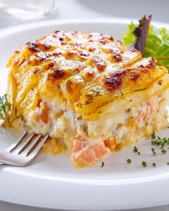 Assiette avec une tartiflette au saumon au Air Fryer, gratinée et fondante.